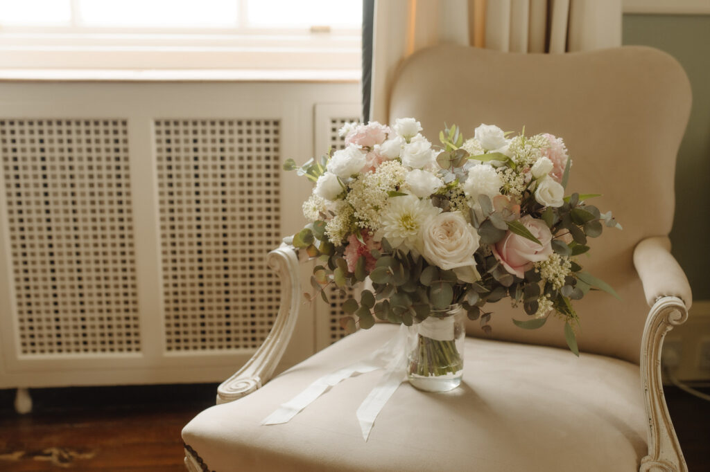 Bridal bouquet sits on a cream chair at Kinmount House wedding