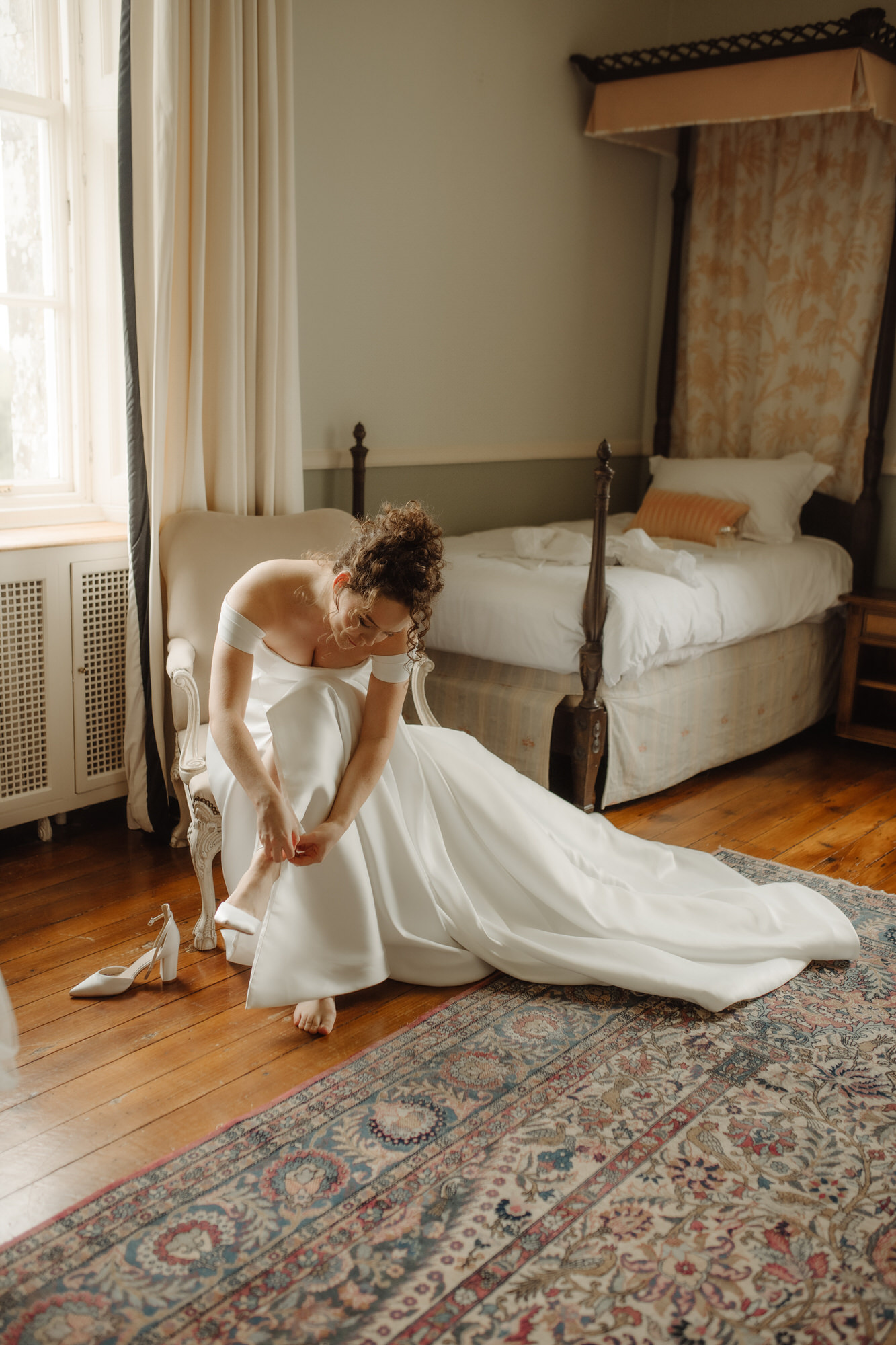 Bride puts on her wedding shoes at Kinmount House wedding