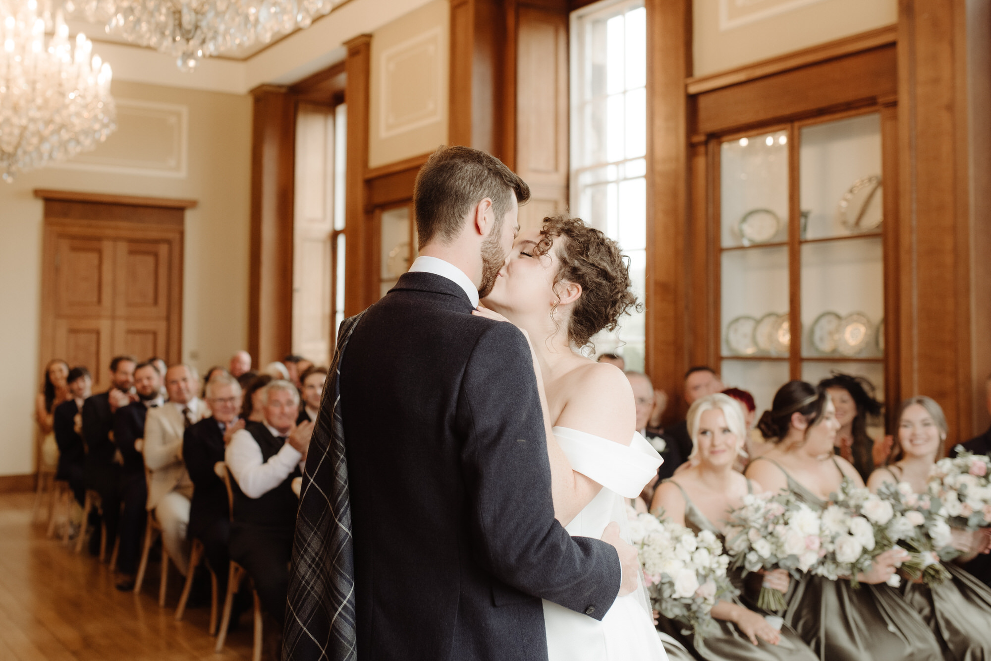 Bride and groom kiss during their wedding ceremony at Kinmount House wedding