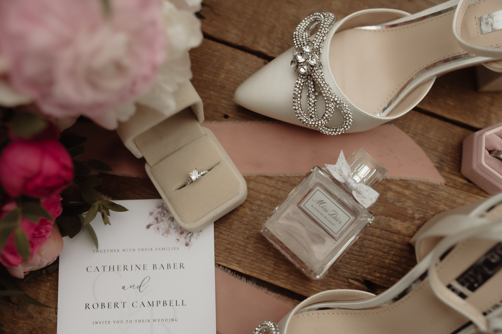 Wedding ring and bridal perfume on a table at The Byre at Inchyra.