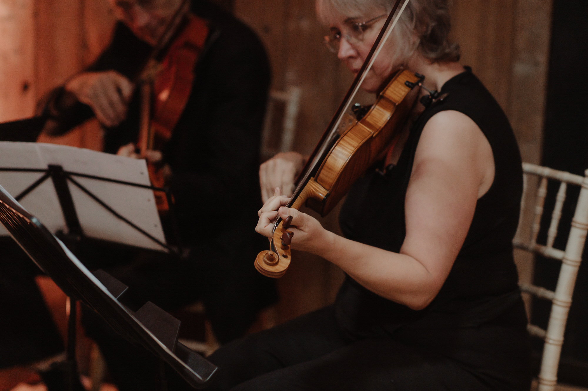 Violinists plays music during wedding ceremony at the Byre at Inchyra.