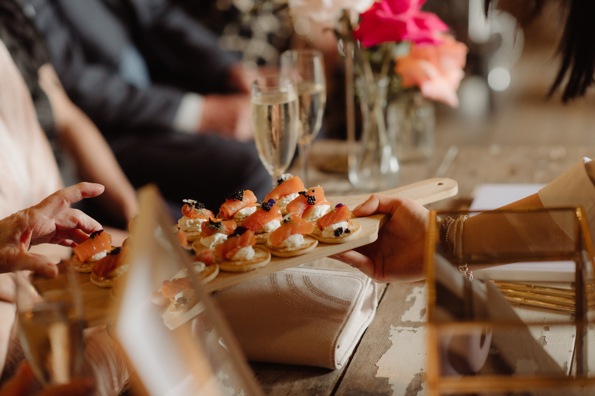 Salmon and cream cheese canapes on a wooden board are served at the Byre at Inchyra.