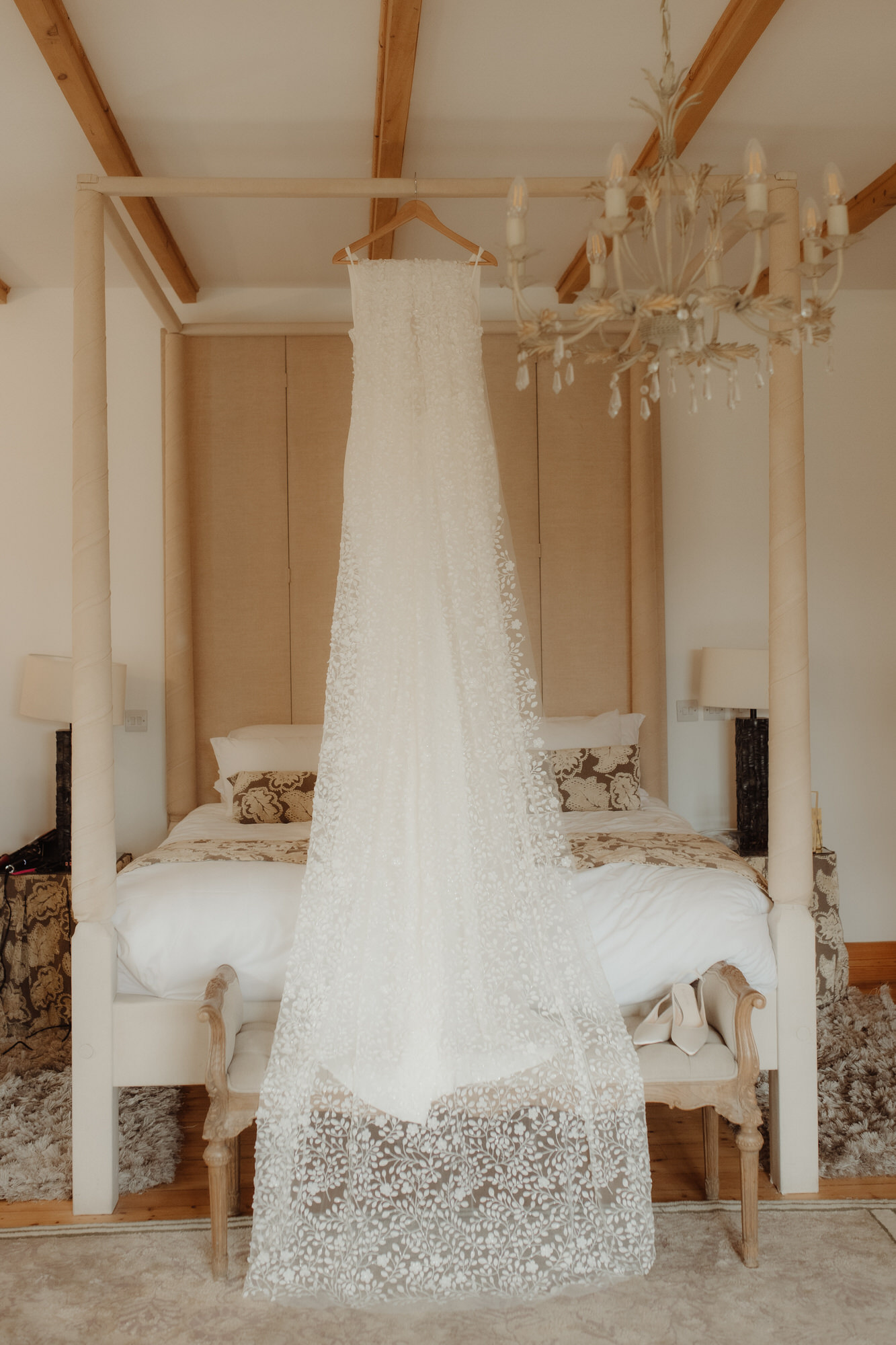 Wedding dress hangs on four poster bed in Achnagairn Castle's bridal suite.