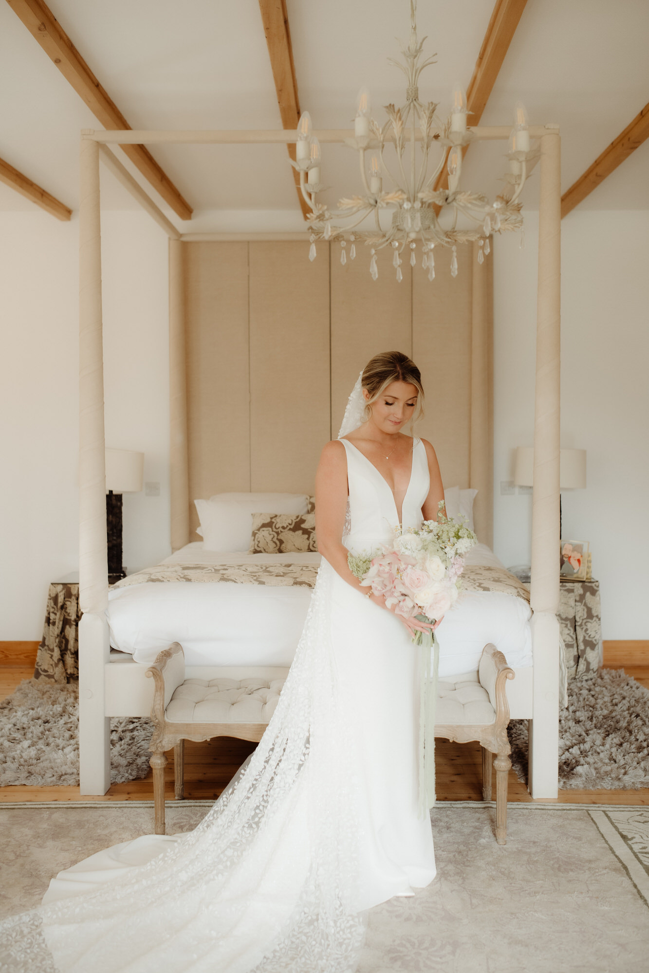 Bride posses with her wedding bouquet at Achnagairn Castle.