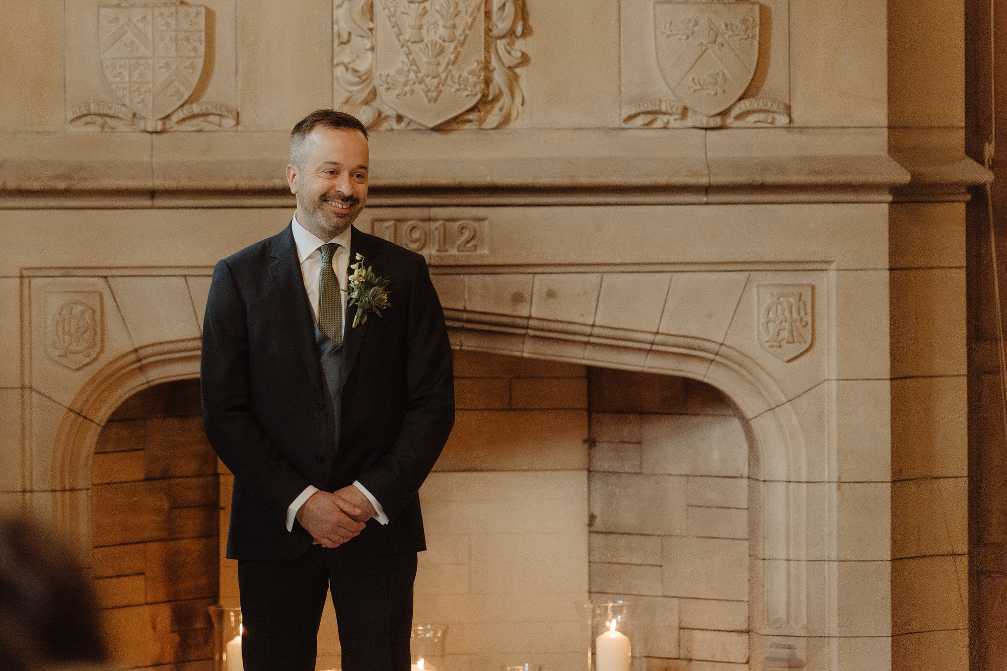 Groom smiles as he waits for his bride at Achnagairn Castle.