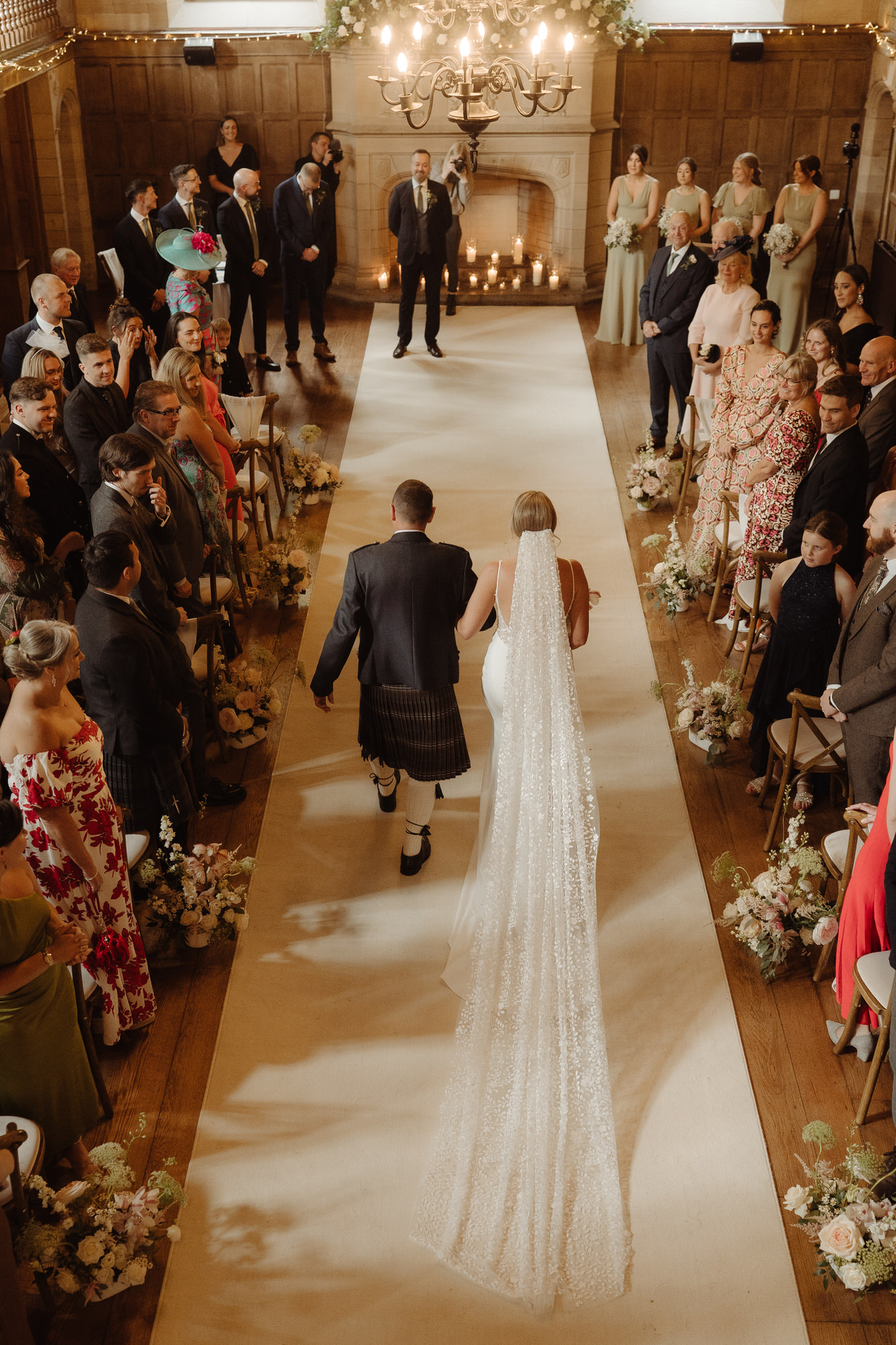 Aerial view of bride and her father walking down the aisle at Achnagairn Castle.