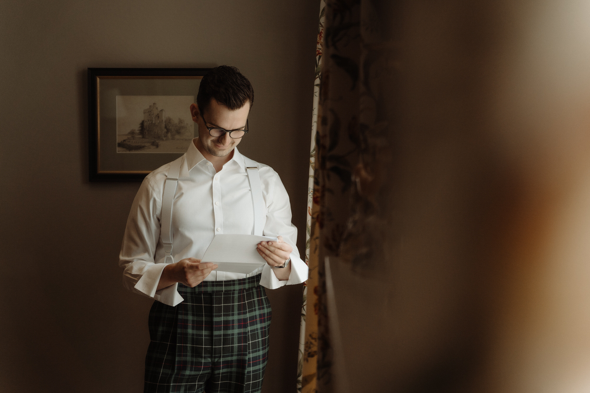 Groom reads a note at Rosebery Steading wedding venue.