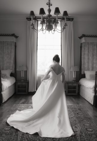 Bride gets her wedding dress on in grand bedroom at Kinmount House. Black and White.